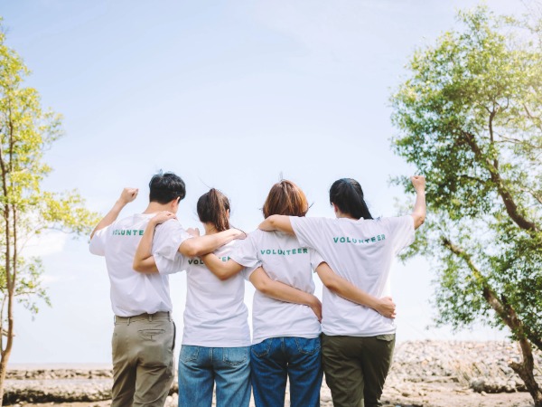 Volunteering, Four people with volunteering T-shirts on