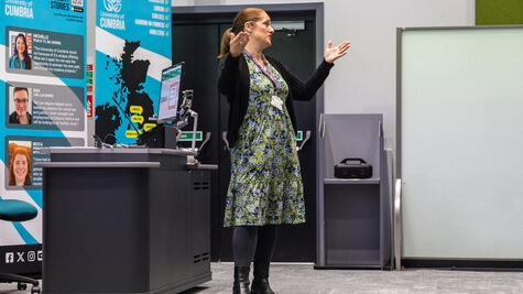 A woman standing at the front presenting