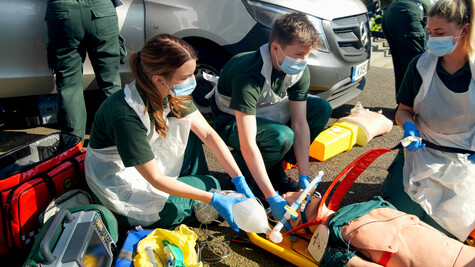 Two student paramedics working.
