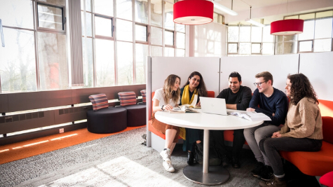 A group of students sitting around a table.