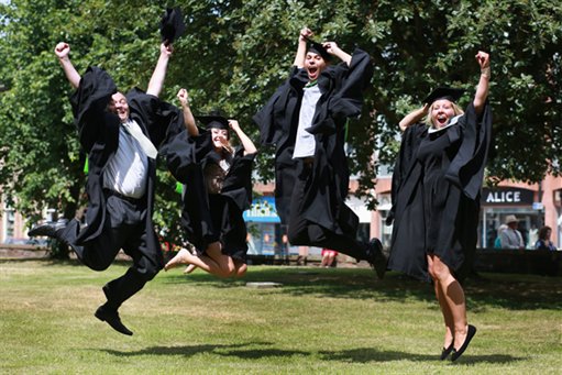 FourGraduatesJumping-Cropped-511x341, A group of young people jumping for joy at their graduation 