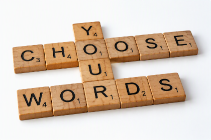 A set of wooden tiles displaying the phrase 'choose your words'