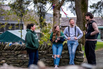 A group of student on the Ambleside campus talking.