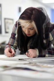 Student focusing on written work.