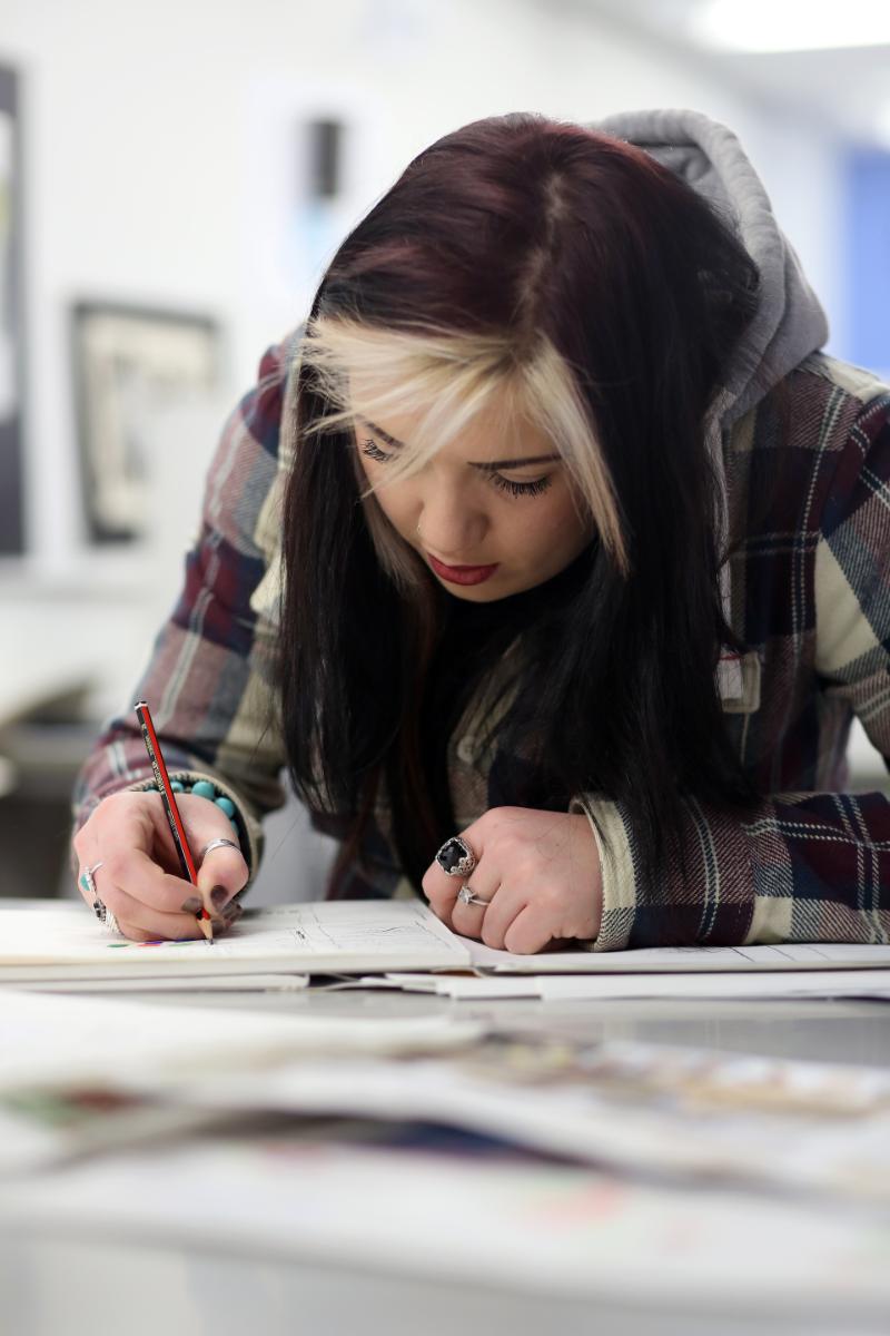 Student focusing on written work.