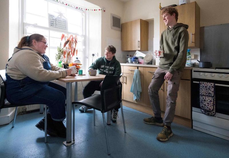 Students sitting around a table in student accommodation.