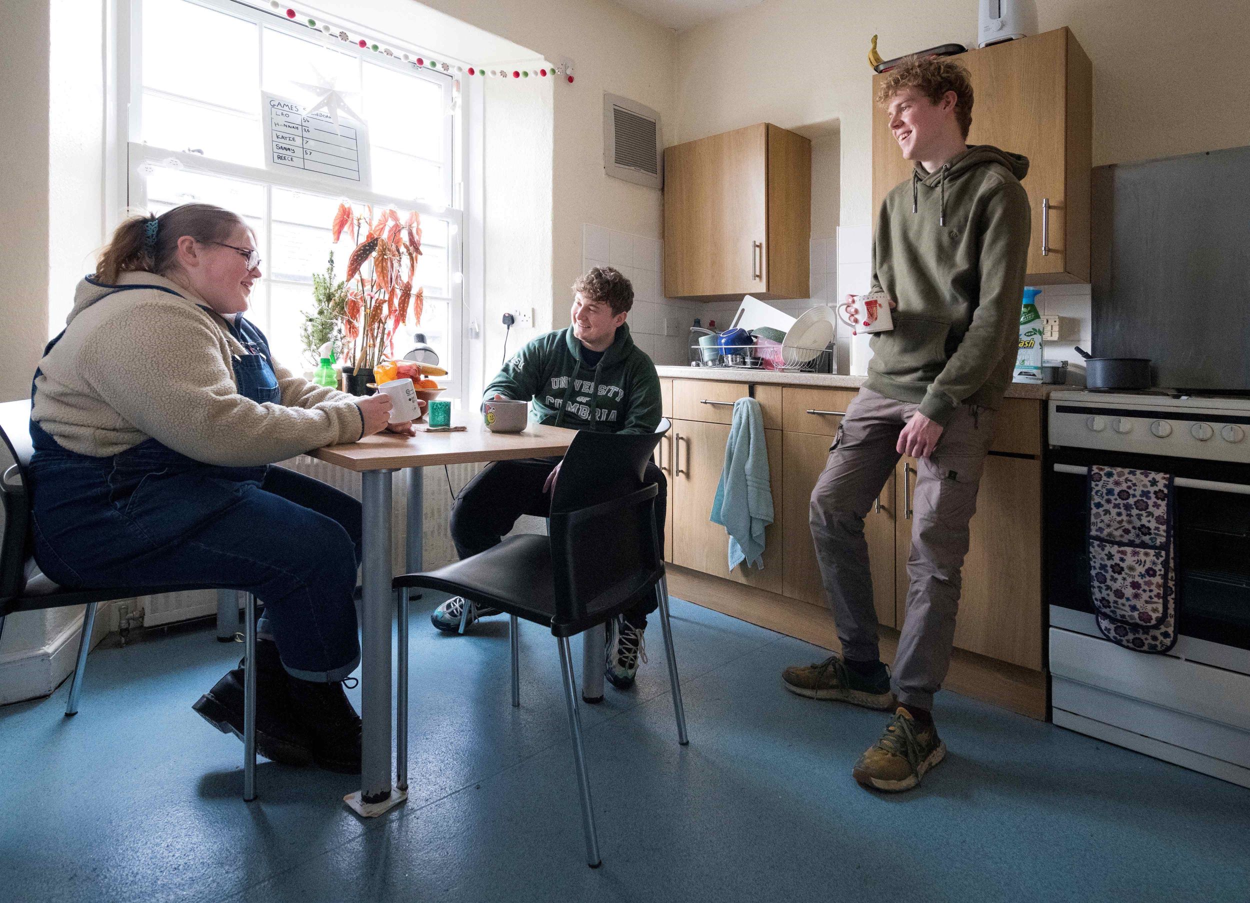 Three students enjoying a drink in Ambleside accommodation