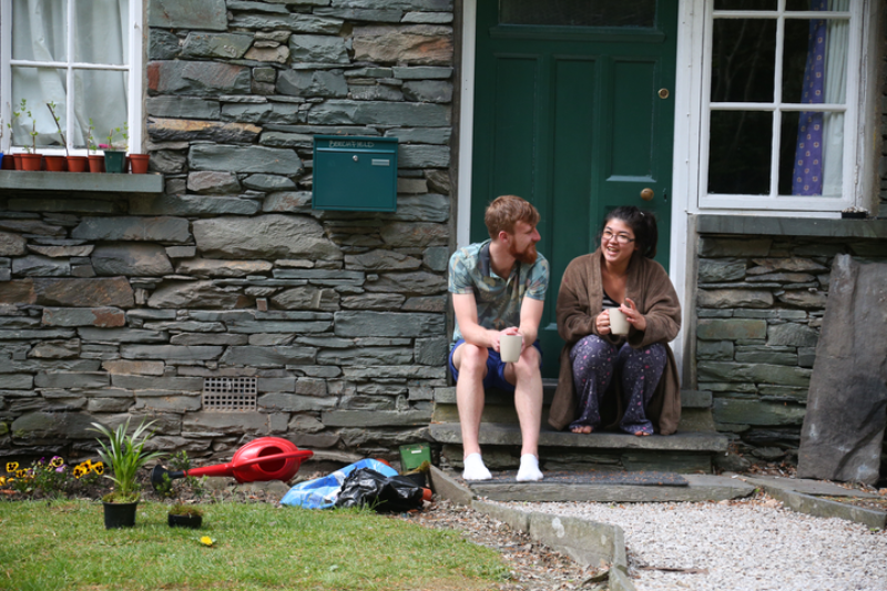 Two students sat in a doorway