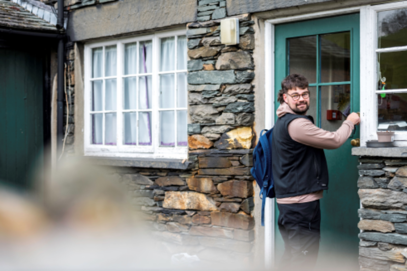 A student opening a door at campus accommodation