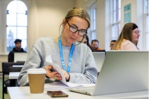 A student studying at a laptop
