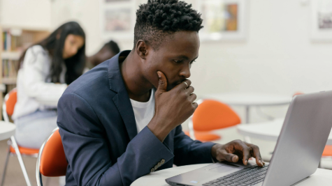 A man pondering over a laptop