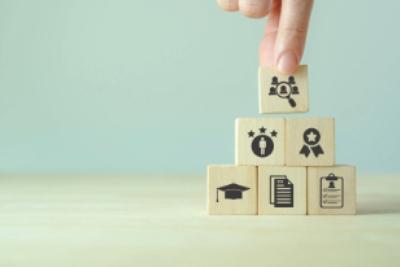 An image of building blocks with engravings related to gaining qualifications. 