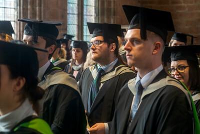 An image of two male students on graduation day during the ceremony