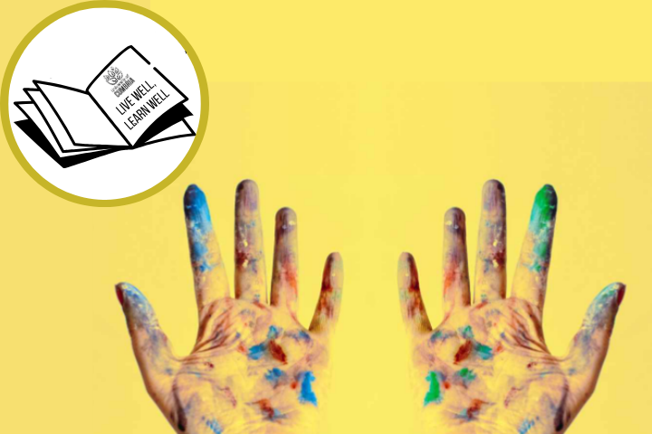 The image is of a pair of hands, facing palm up, covered in paint. In the top left of the image is a logo for the Live Well Learn Well UoC blog