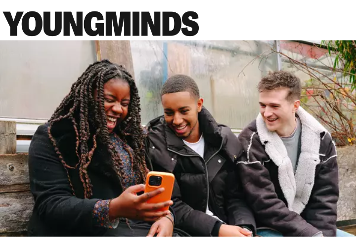 the image shows 3 students looking at a phone and laughing with the 'Youngminds' logo at the very top of the image