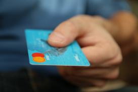 A student holding a bank card.