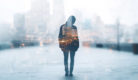 A silhouette of a person with a cityscape background.