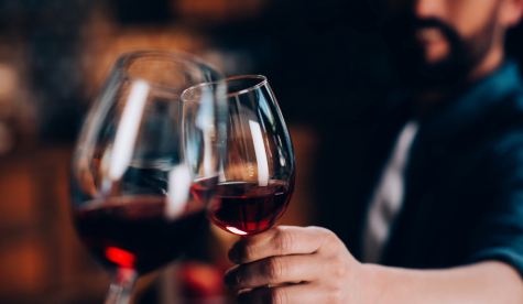 An image of two wine glasses clinking together.