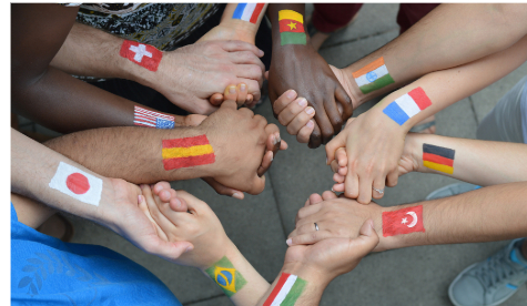 A group of adults holding hands with flags painted on their hands.