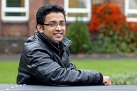 StudentsSatOnBench, A Student sat smiling on a bench 