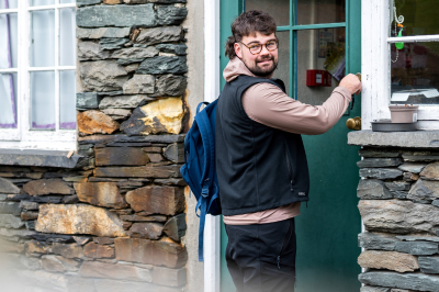 A student opening a door at campus accommodation